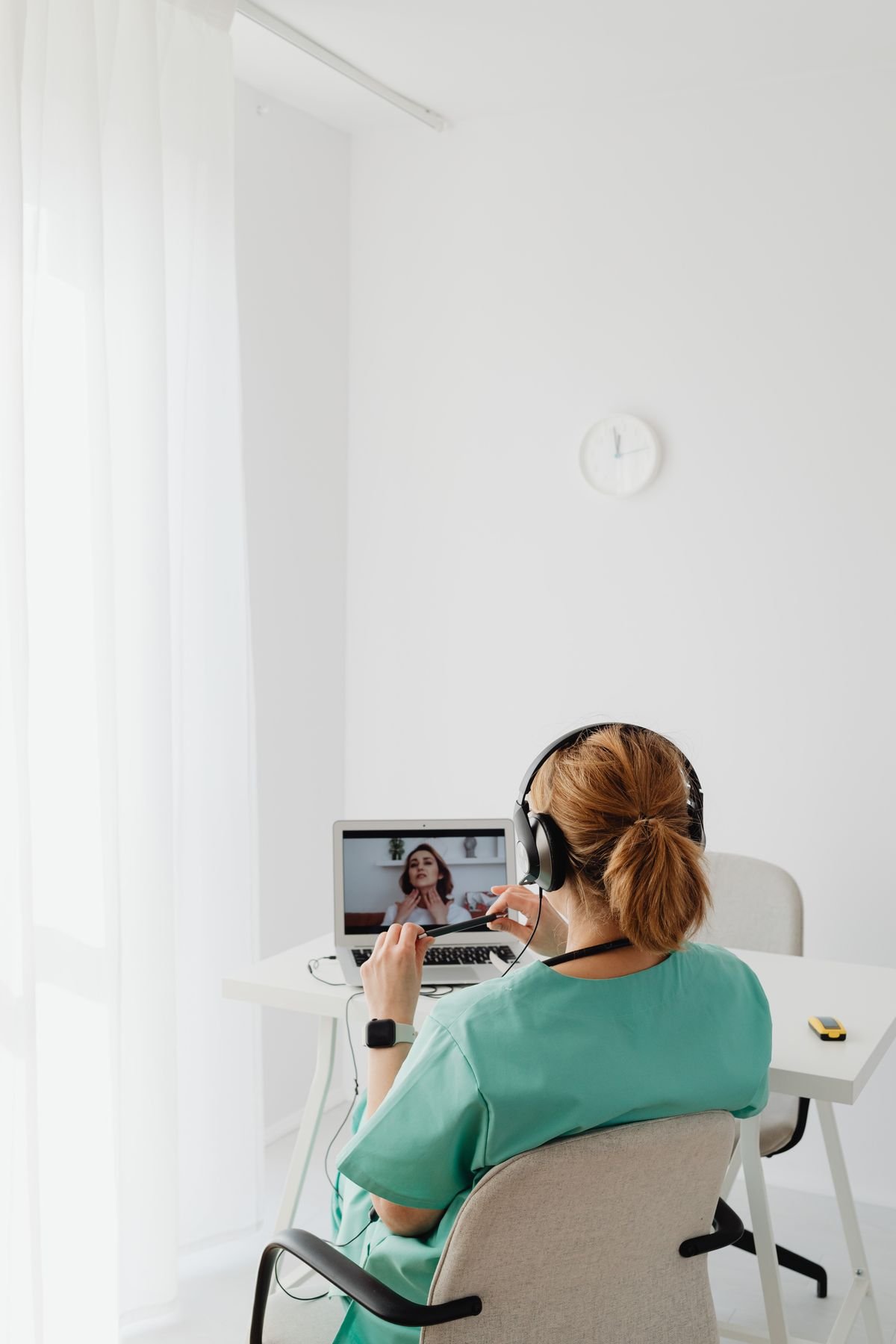 Profissional de saúde em teleconsulta usando laptop, tecnologia de transcrição médica com IA
